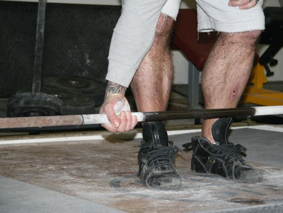 A Weightlifter Consumes a Strength Coach