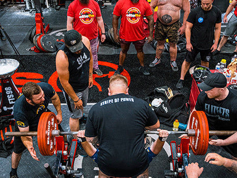 ariel shot of lifters spotting a guy while benching|Year Plan Ashley Jones