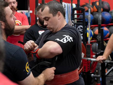 man putting wraps on wrists
