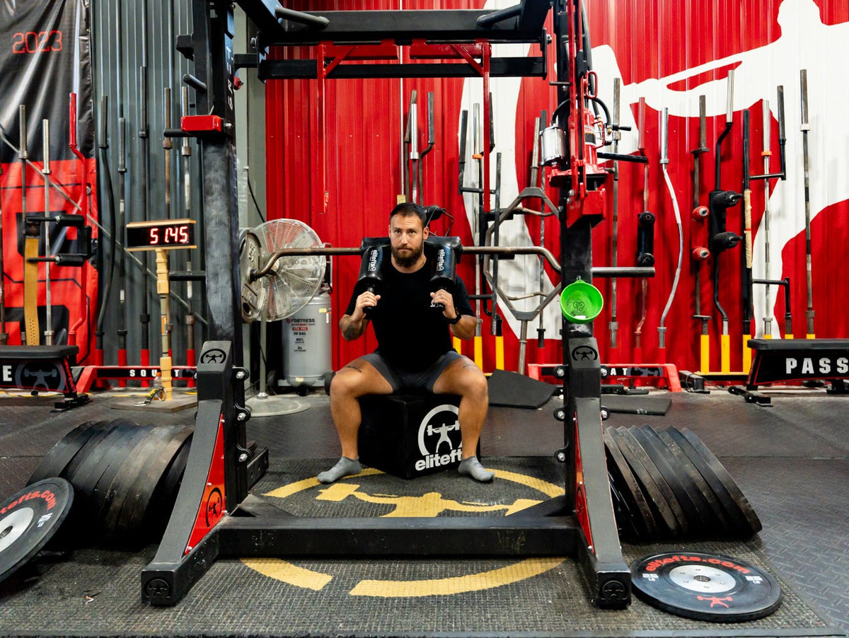 Lifter using the elitefts Squat Box with a safety squat bar in the elitefts gym