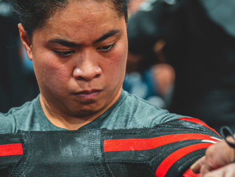 woman placing shirt on to bench