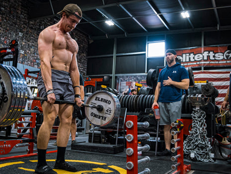 shirtless man deadlifting in gym