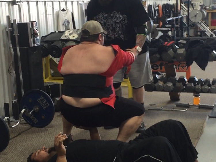 Nate anchors his hand in while benching Walter for charity video