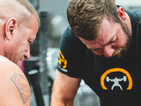 guys supporting lifter on bench
