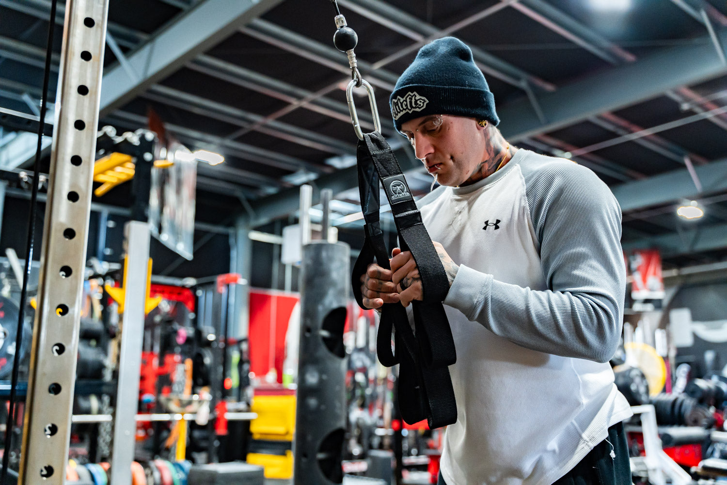 Person adjusting resistance bands in a gym setting