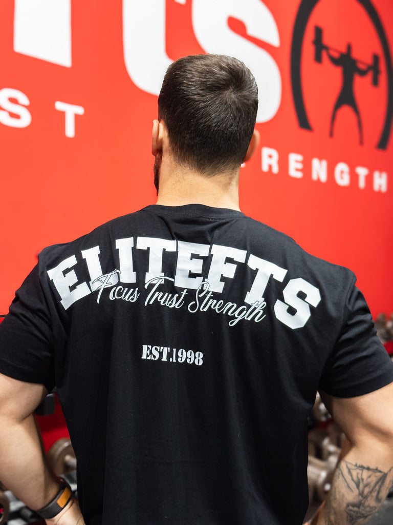 Person wearing a black 'ELITEFTS' t-shirt with a red background featuring a logo.