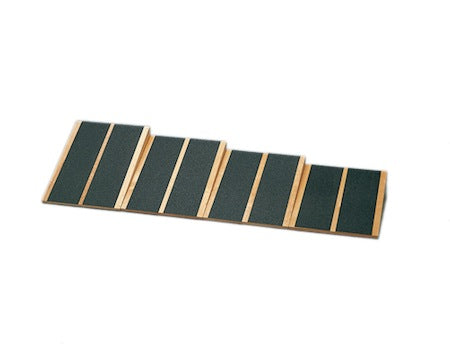 Wooden ramp with green surface on a white background