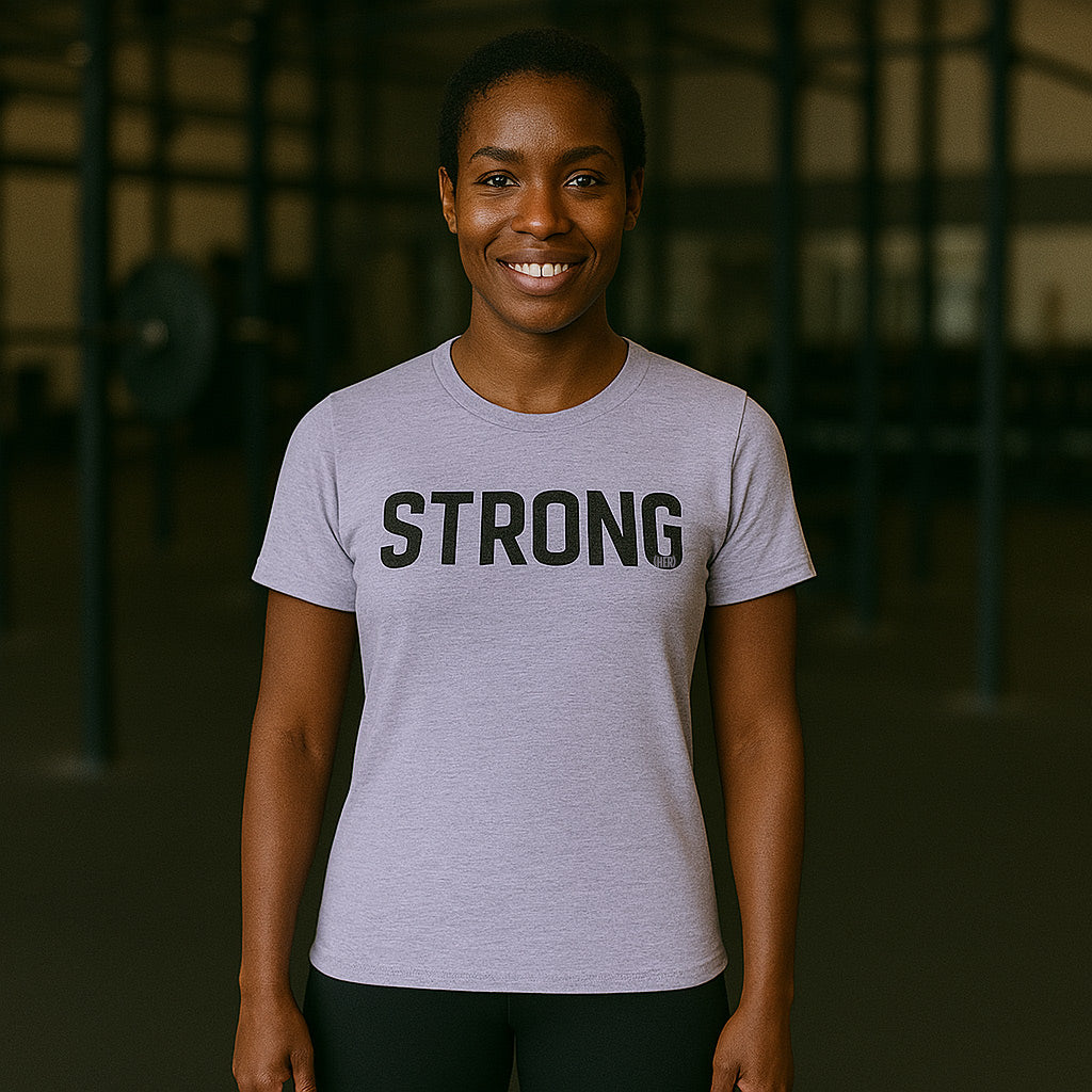 Person wearing a gray t-shirt with 'STRONG' printed on it in a gym setting-all-groups