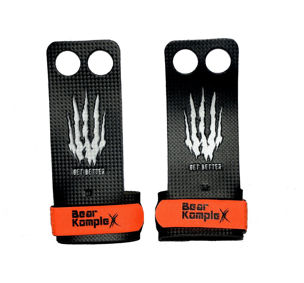 Two black and orange grip patches with 'Bear KompleX' branding on a white background.