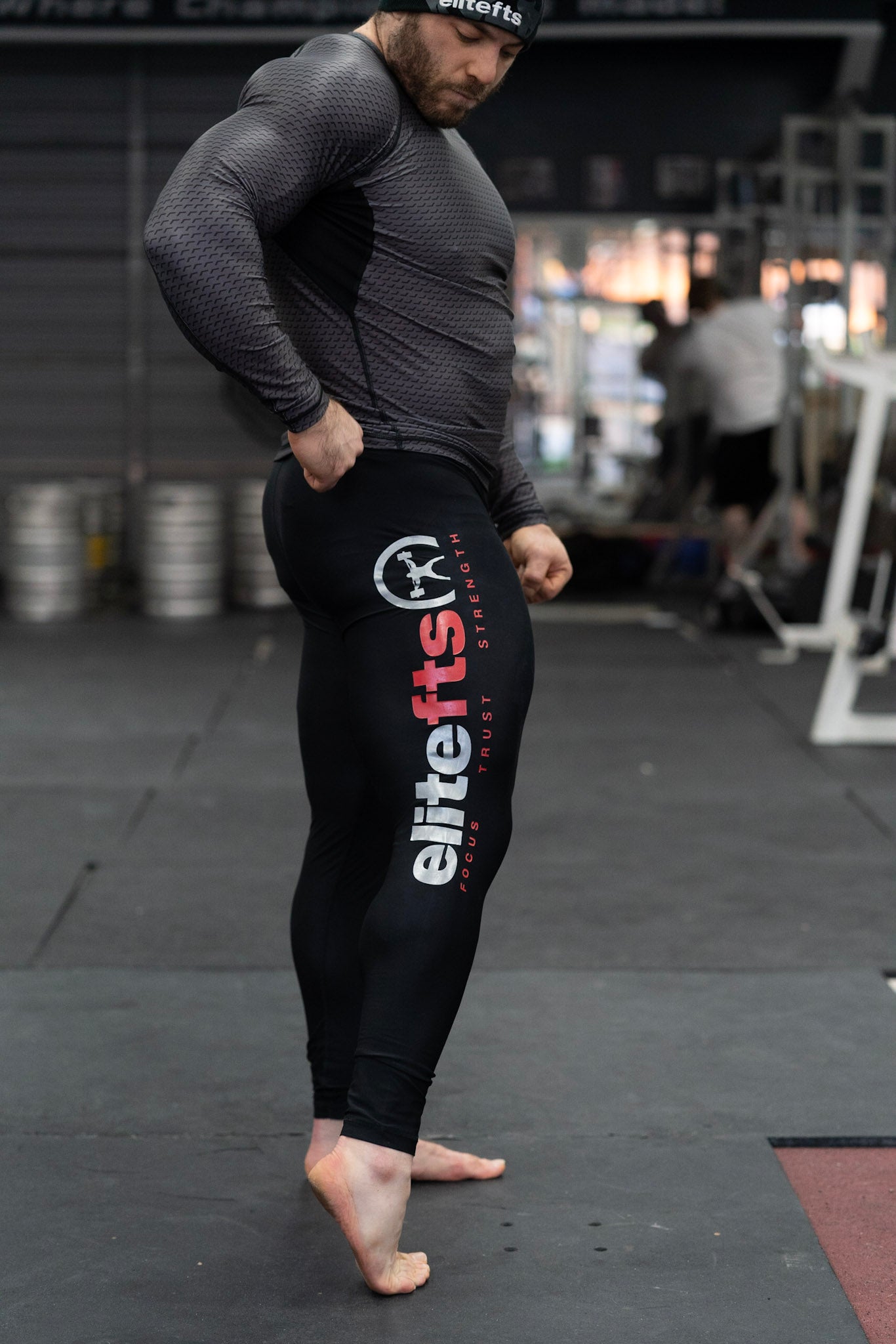 a pair of black compression pants with a decal on the side being worn