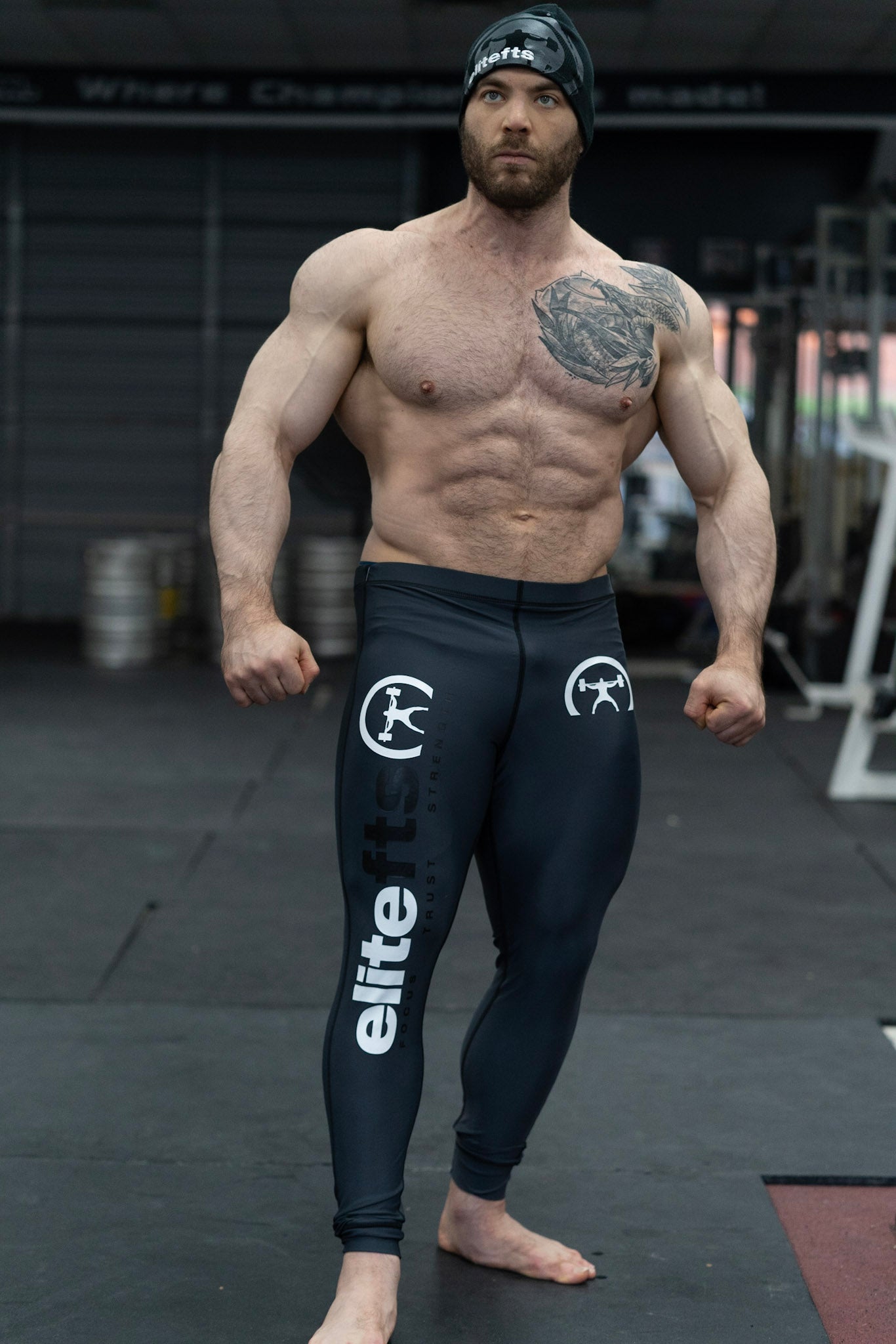 someone wearing a pair of dark gray compression pants with decals on various parts of the product