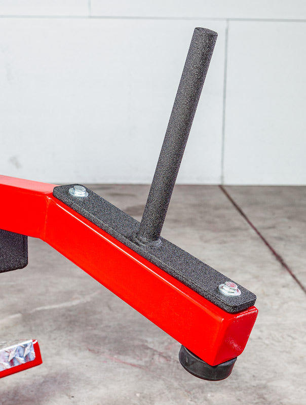 Red metal jack stand with a black handle on a concrete floor.
