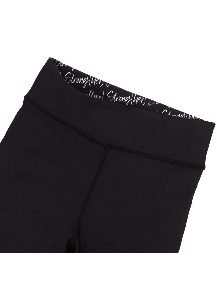 Black leggings with text on the waistband against a white background