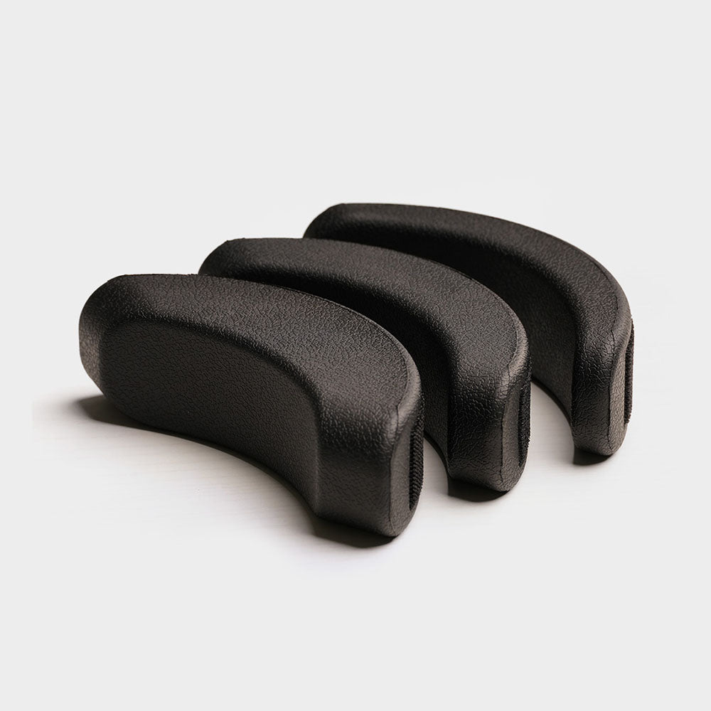 Three black foam roller tools on a light gray background