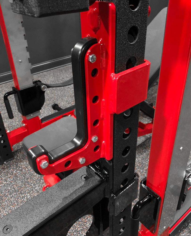 Close-up of a red and black weightlifting rack with visible bolts.