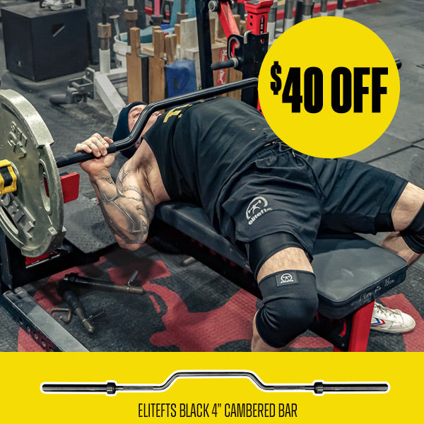 Person bench pressing with a barbell in a gym, promotional text overlay for Elitefts Black 4" Cambered Bar.