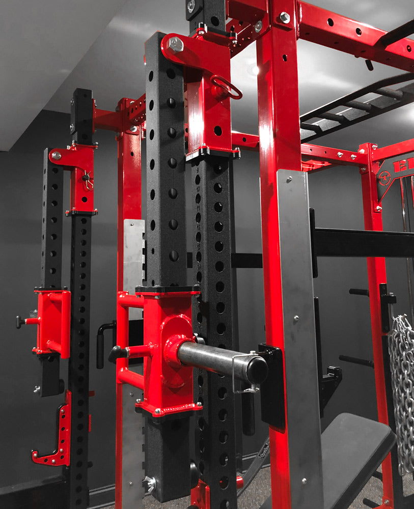 Red and black weightlifting rack in a gym setting