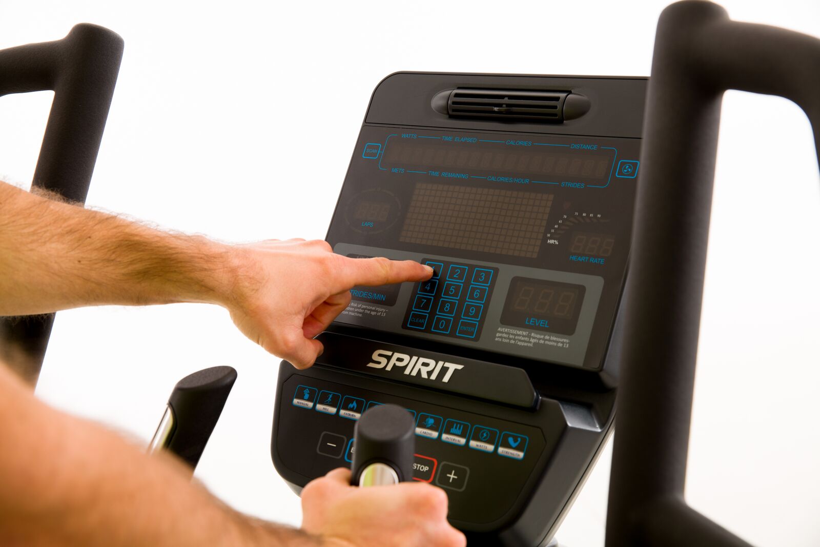Person using a Spirit exercise bike console with a blurred background