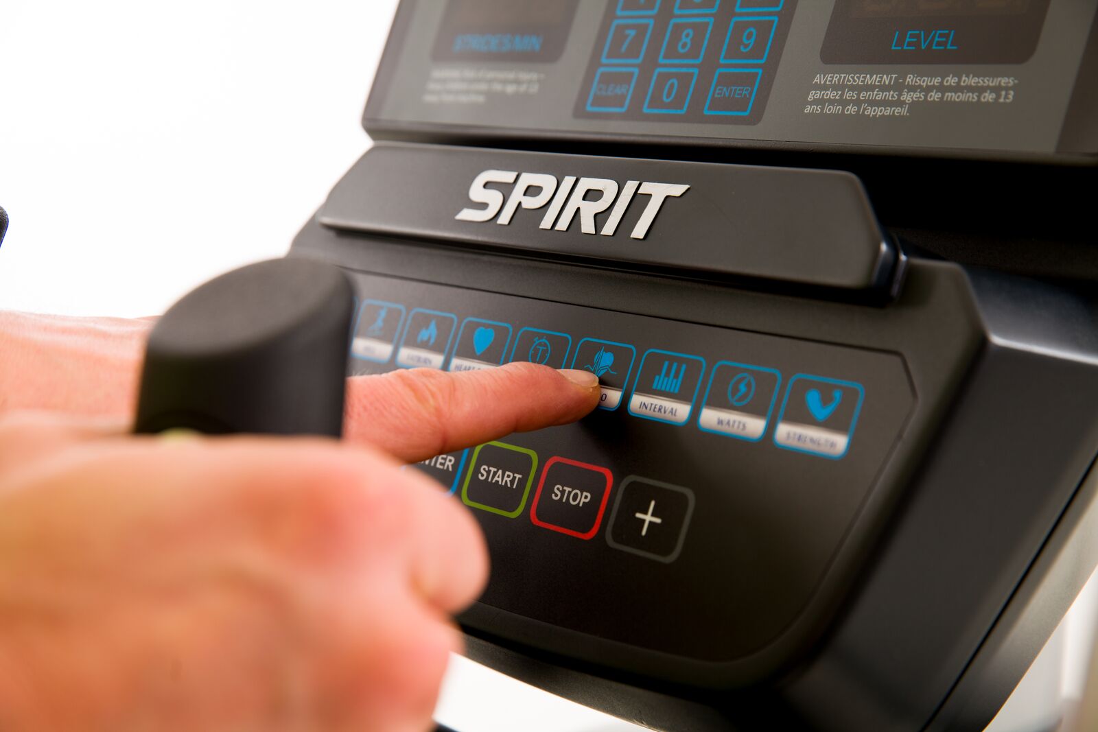 Person using a treadmill control panel with 'Spirit' branding