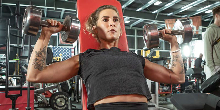 athlete overhead pressing with dumbbellssupport the podcast