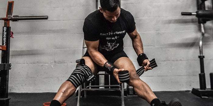 Aging powerlifter wrapping knees