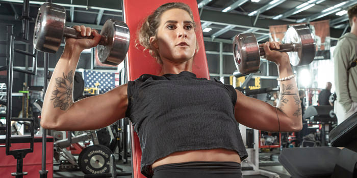 seated overhead press with dumbellspre and post of bloating and non bloating for client