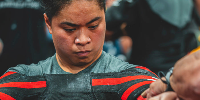 woman placing shirt on to bench