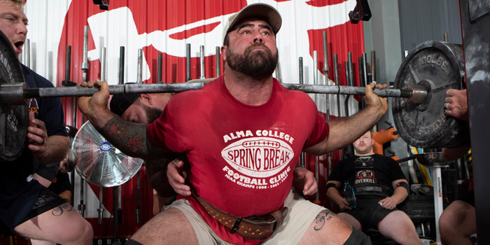 guy squatting with straight bar