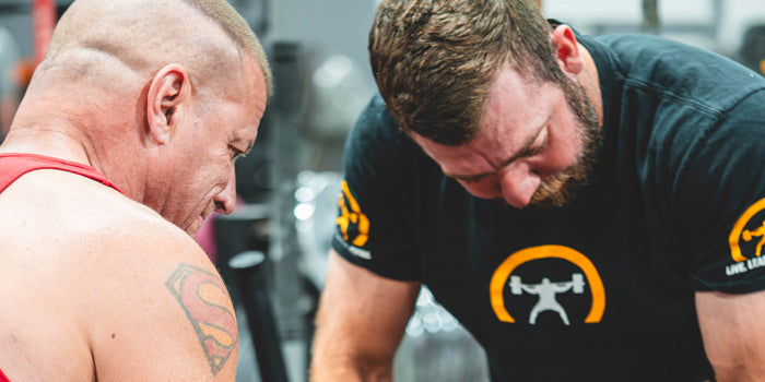 guys supporting lifter on bench