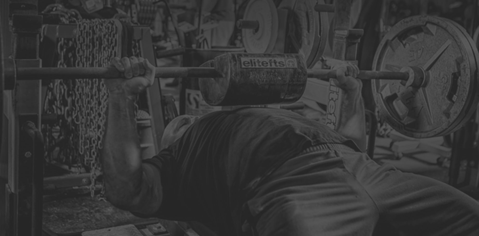 Man lifting a plate loaded barbell
