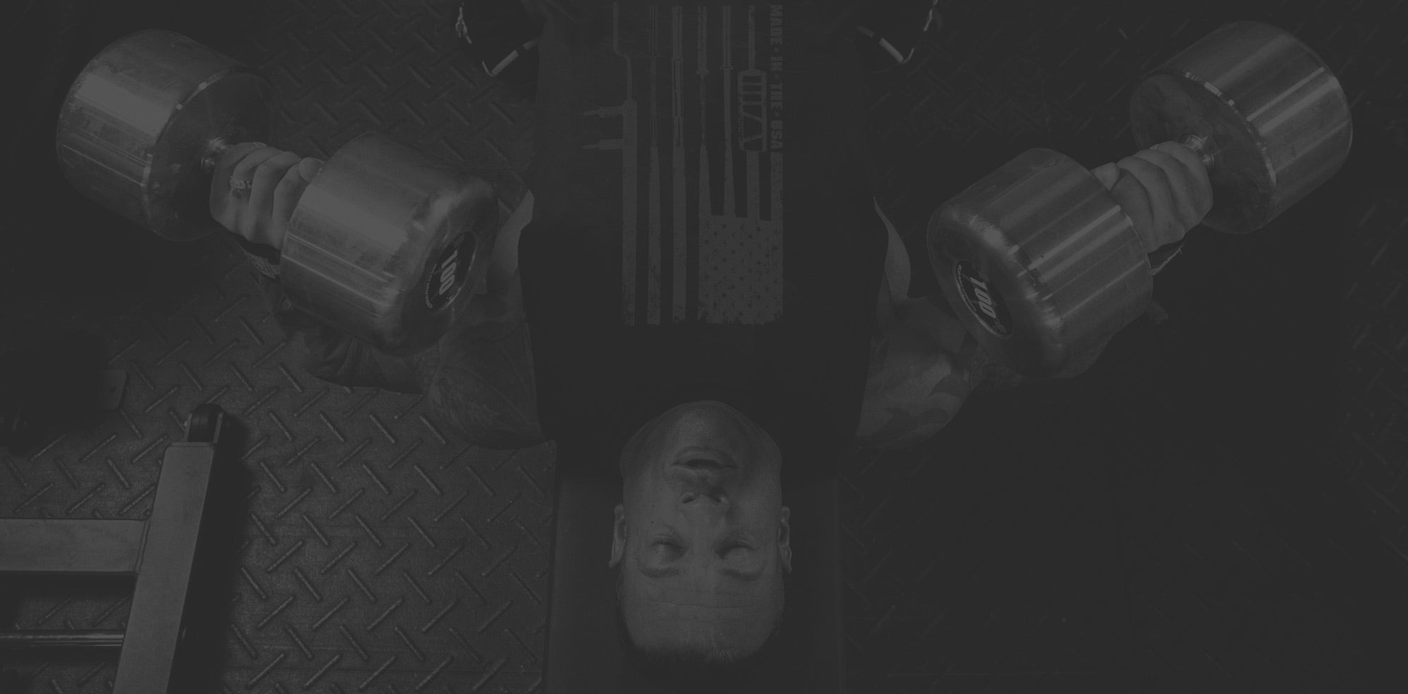 Man on bench lifting dumbells