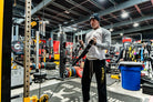 Person using resistance bands in a gym setting with various equipment around