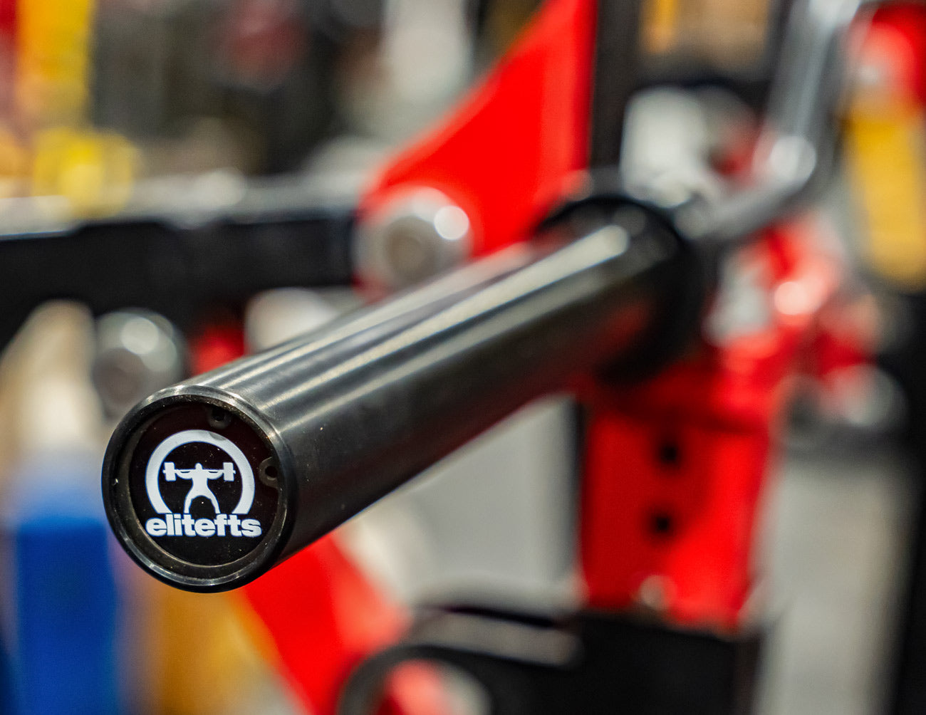 Close-up of a black handlebar with a logo on a blurred background