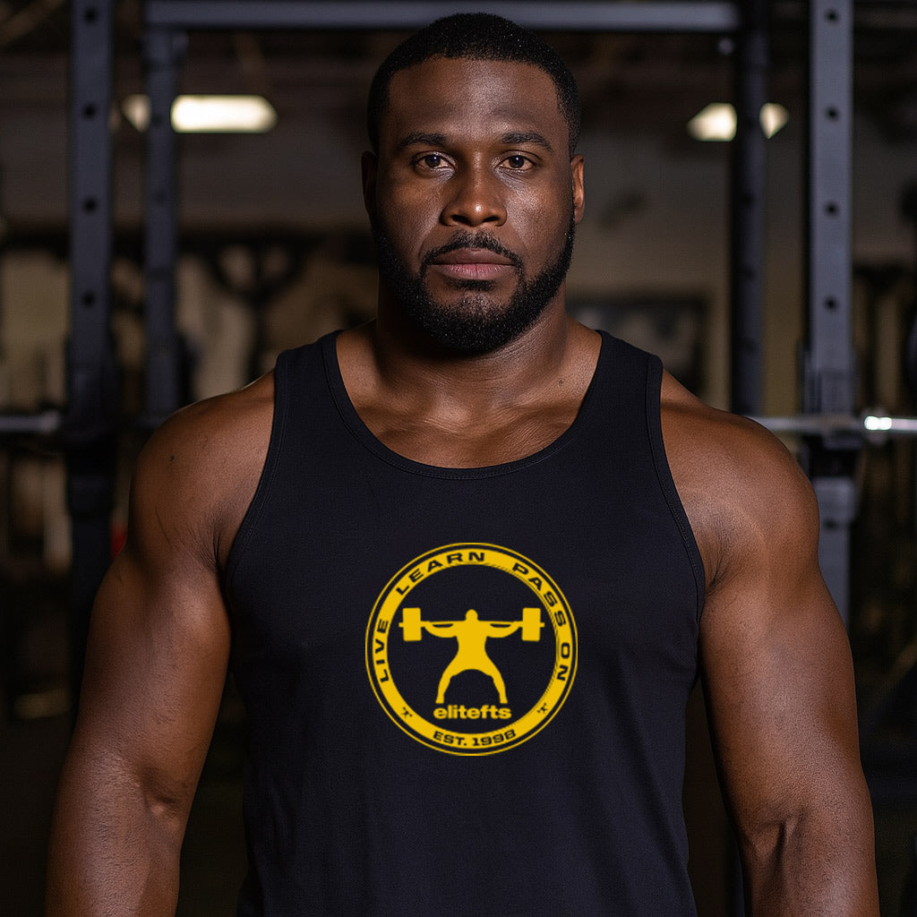 Man wearing a black tank top with a yellow logo in a gym setting-all-groups