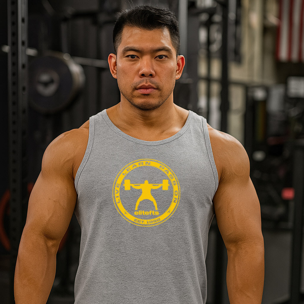 Man wearing a gray tank top with a yellow logo in a gym setting-all-groups
