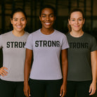Three women wearing t-shirts with the word 'STRONG' on a dark background-all-groups