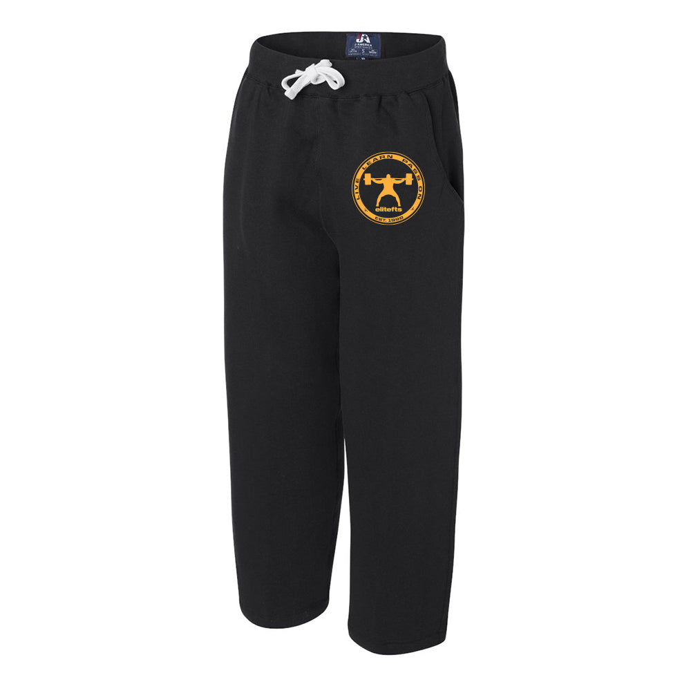 a pair of black open bottom sweat pants with a  yellow coin decal next to the left pocket