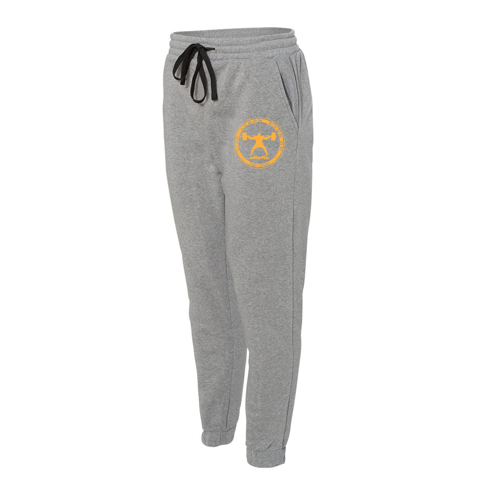a pair of gray fleece jogger pants with the with a yellow coin decal on the left pant leg