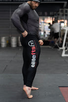 a pair of black compression pants with a decal on the side being worn