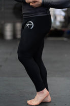 a pair of black compression pants with a decal on the side being worn