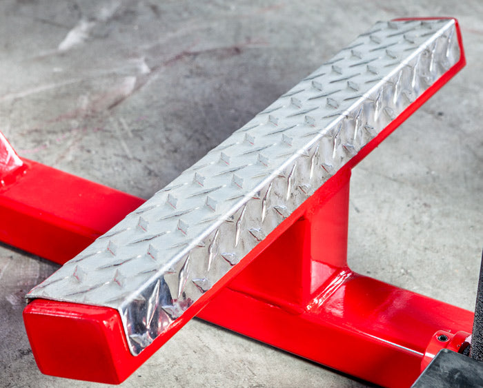 Red metal jack stand on a concrete floor