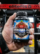 Hand holding a container of 'Extreme Clean Smelling Salts' with a gym background