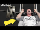 Man performing a bench press with a barbell, wearing a shirt with 'Get Vertical' text, against a black background with Elitefts logo.