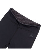 Black leggings with text pattern on waistband against a white background