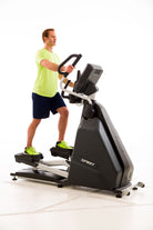 Man exercising on a Spirit brand elliptical machine against a white background