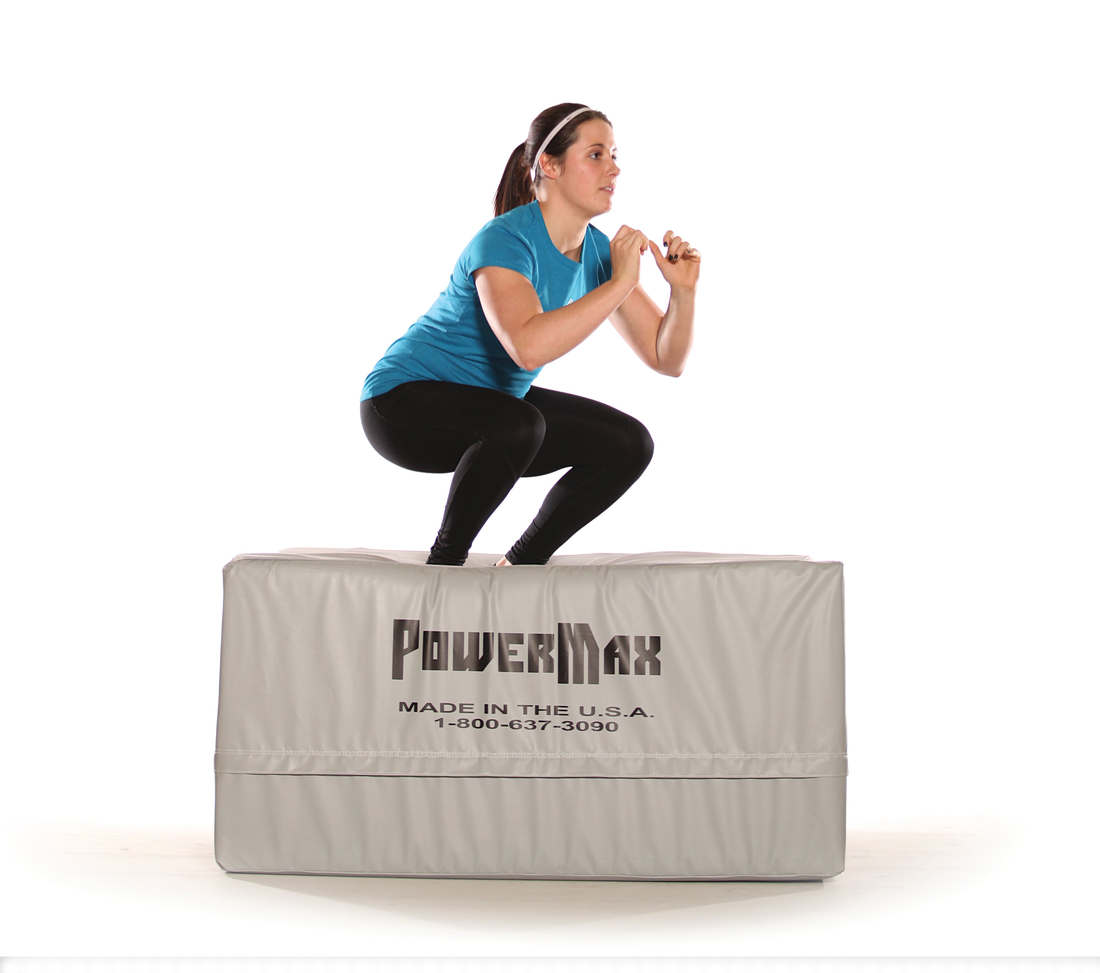 Woman performing a squat on a PowerMax product with a white background