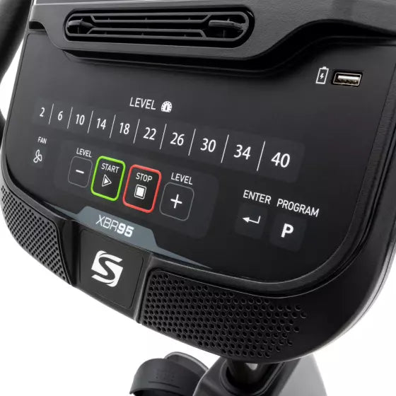 Control panel of a piece of exercise equipment with digital display and buttons.